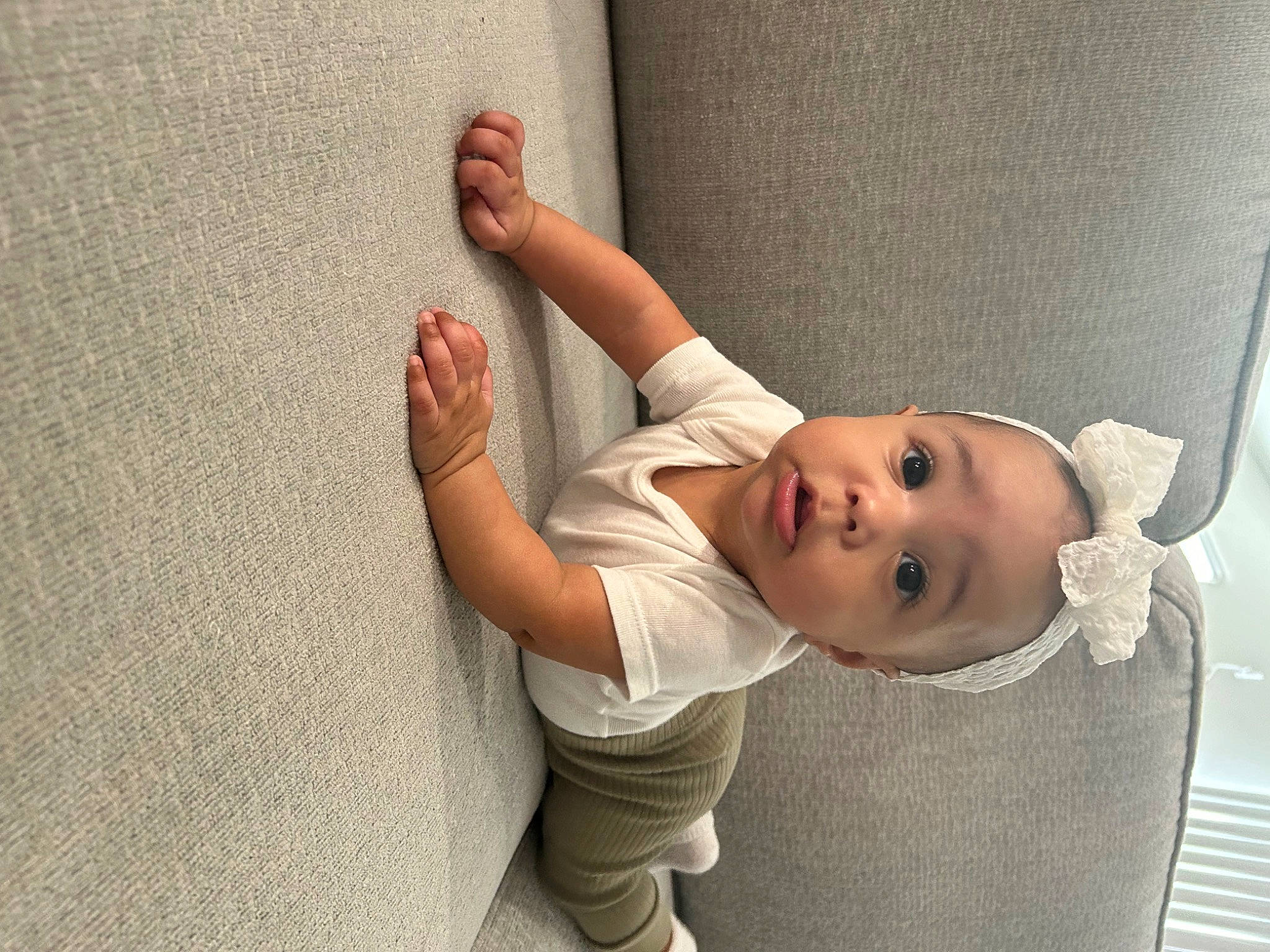 Cali is registered to the contest to win money with this photo: baby, baby_toddler_clothing, child, comfort, elbow, finger, flooring, foot, gesture, happy, human_body, human_leg, leg, linens, person, sleeve, smile, thumb, toddler, wood