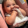 baby, infant, child, car_seat, pink, smiling, happy, portrait, face, eyes, hands, cloth, blanket, seated, indoors, vehicle, safety_harness, brown_hair, candid, close_up