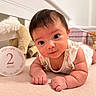 baby, infant, child, tummy_time, portrait, smiling, wide_eyed, brown_hair, lying_down, blanket, plush_toy, bunny, milestone_card, two_months, nursery, indoor, pink, romper, close_up, cute