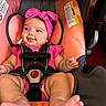 Angelica joined the competition — help win amazing prizes! baby, infant, child, car_seat, harness, pink_clothing, headband, bow, smiling, happy, face, portrait, sitting, indoors, vehicle, safety_seat, feet, hands, close_up, photography