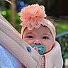 baby, infant, child, portrait, face, eyes, pacifier, headband, flower, lace, pink, wrapped, blanket, carrier, outdoor, greenery, bokeh, closeup, cute, smiling