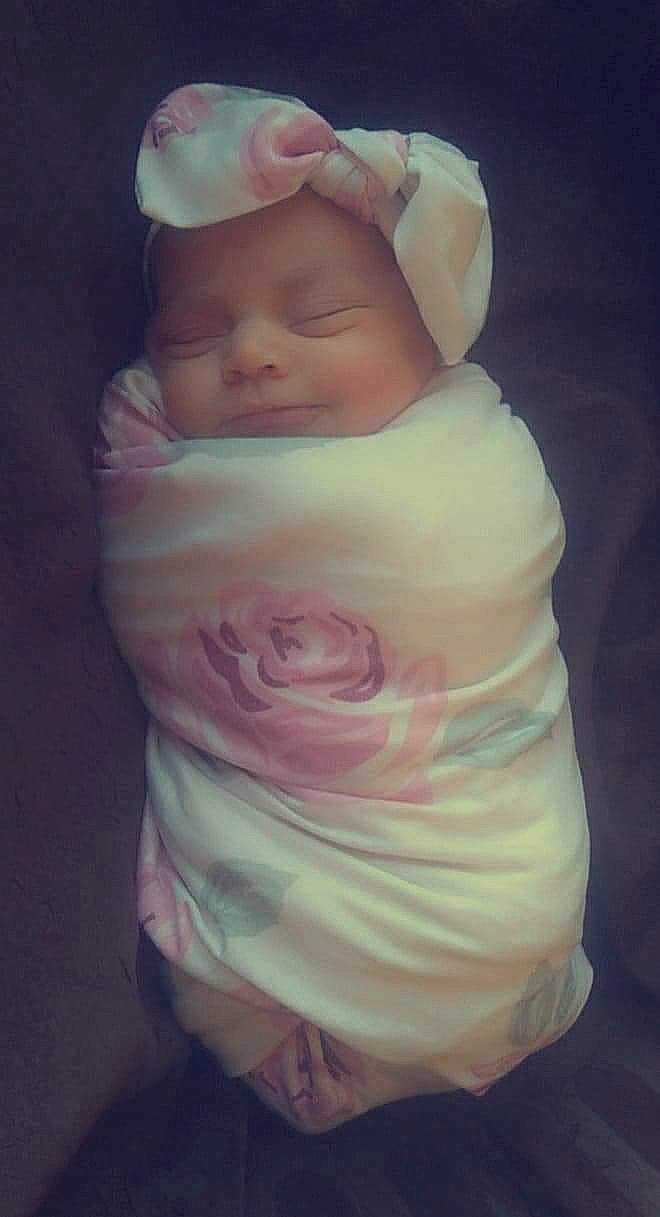 Jolene is registered to the contest to win money with this photo: abdomen, baby, baby_products, baby_toddler_clothing, chest, comfort, dress, happy, hat, head, headwear, human_body, linens, lip, person, pink, skin, sleeve, smile, thumb