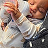 Eziah joined the competition — help win amazing prizes! baby, bottle, sleeping, pajamas, cute, infant, hand, face, cozy, blanket, pattern, puppy_print, child, indoor, peaceful, curly_hair, feeding, resting, person, closeup