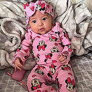 Aurora joined the competition — help win amazing prizes! baby, bed, blanket, child, comfort, cozy, cute, headband, indoors, infant, minnie_mouse, patterned_sheet, person, pink_clothing, portrait, resting, sleepwear, socks, soft_texture, young_child