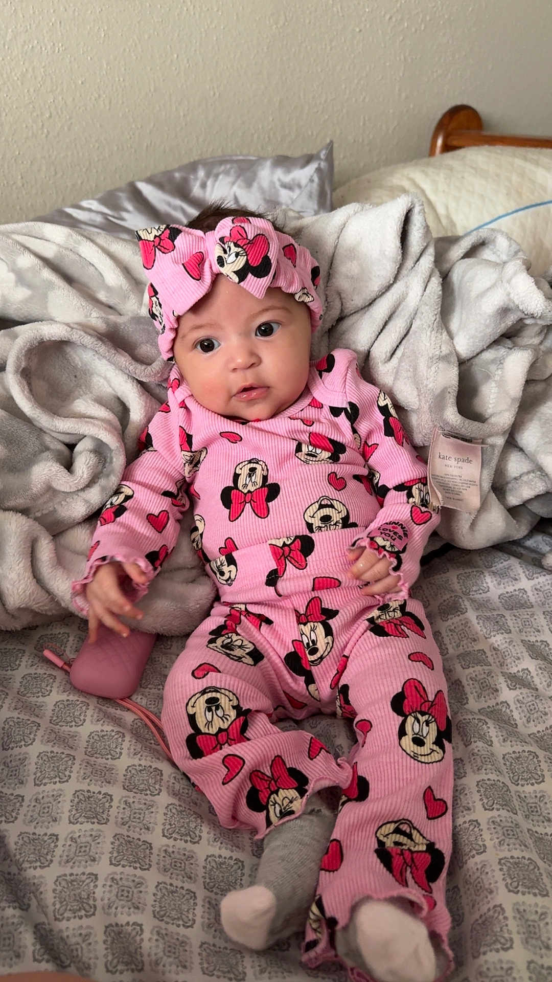 Aurora joined the competition — help win amazing prizes! baby, bed, blanket, child, comfort, cozy, cute, headband, indoors, infant, minnie_mouse, patterned_sheet, person, pink_clothing, portrait, resting, sleepwear, socks, soft_texture, young_child