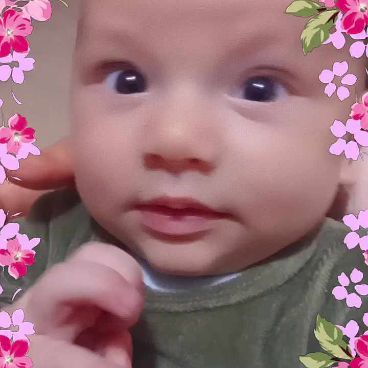 Cyriaque participe au concours pour gagner de l'argent avec cette photo : adorable, baby, background_blur, child, close_up, curious, cute, expression, face, floral_frame, green_clothing, hand, infant, innocence, pink_flowers, portrait, skin, soft_lighting, wide_eyes, young