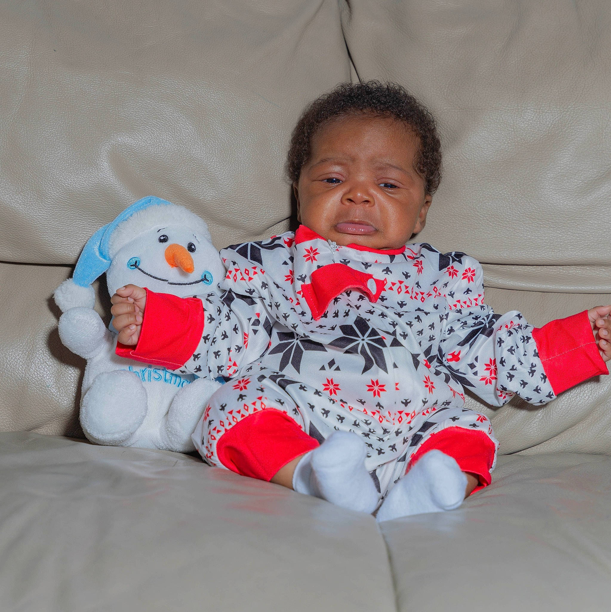 Chris is registered to the contest to win money with this photo: arm, baby, baby_toddler_clothing, comfort, couch, eye, finger, fun, happy, head, human_body, linens, mouth, pattern, person, skin, sleeve, smile, t_shirt, textile