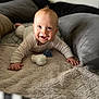 baby, smiling, crawling, blanket, pillow, toy, pacifier, indoor, infant, face, cute, happy, child, person, cozy, soft, clothing, head, hands, portrait