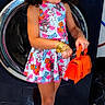 accessories, bracelets, child, colorful, curly_hair, cute, dress, fashion, floor_tiles, flower, girl, home, indoors, looking_down, orange_purse, orange_shoes, playful, standing, washing_machine, yellow_flower