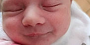 Maria a rejoint le concours — aidez-le/la à gagner de superbes lots ! newborn, baby, infant, sleeping, face, hand, blanket, clothing, pink, skin, closeup, peaceful, cute, resting, indoors, soft, expression, wrapped, smile, young