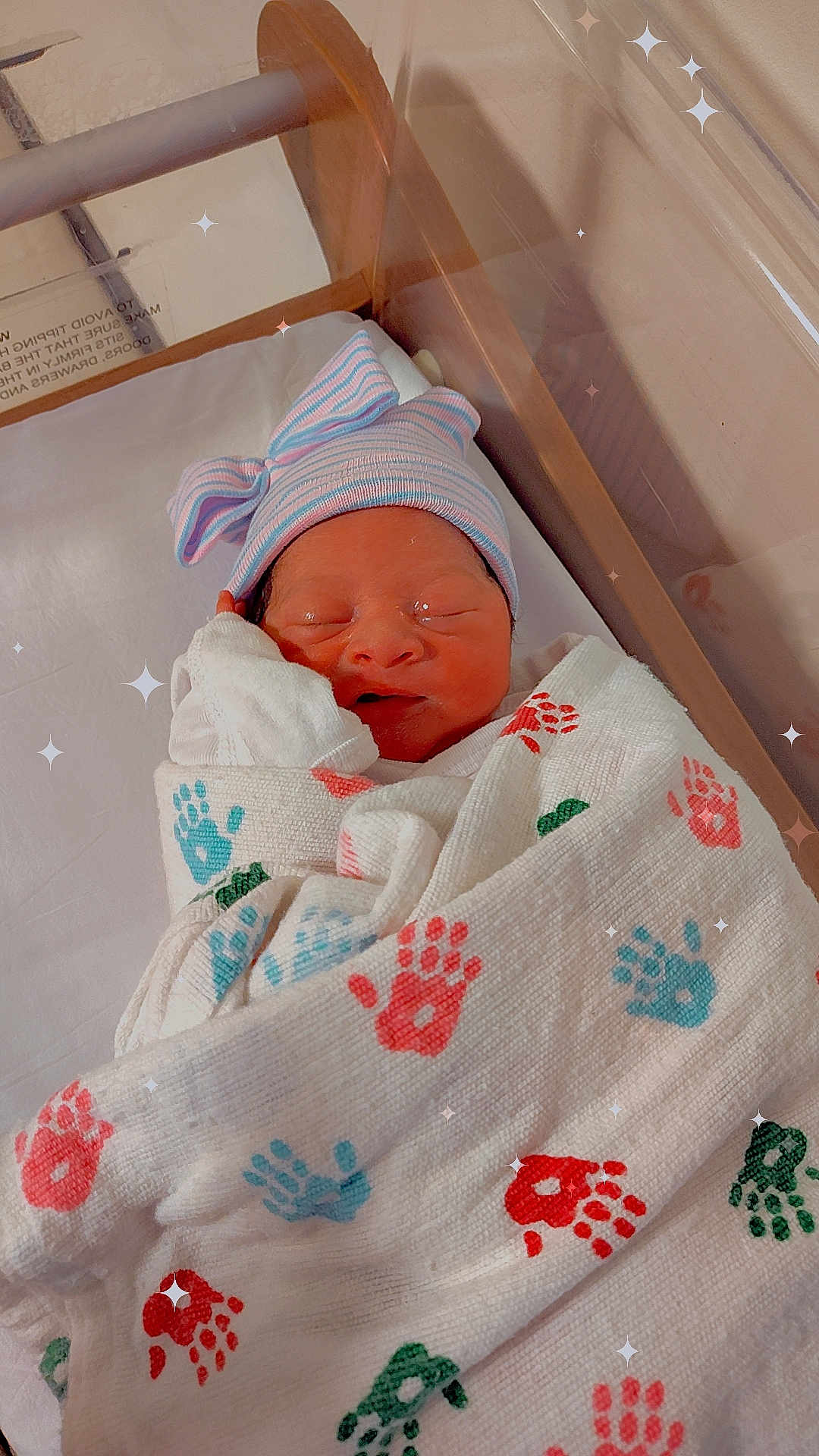 Promise is registered to the contest to win money with this photo: newborn, baby, hospital, bassinet, blanket, handprints, hat, striped, sleeping, wrapped, infant, cute, bow, skin, peaceful, indoors, soft_light, sparkles, portrait, child