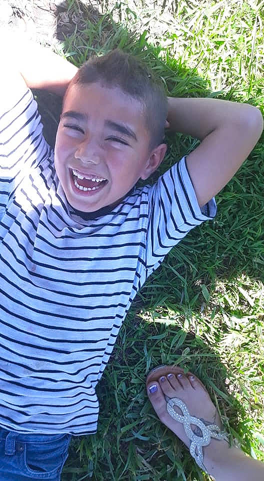 Llo is registered to the contest to win money with this photo: child, cool, face, facial_expression, fun, grass, happy, head, joy, laugh, lawn, male, mouth, nose, person, plant, smile, summer, t_shirt, toddler