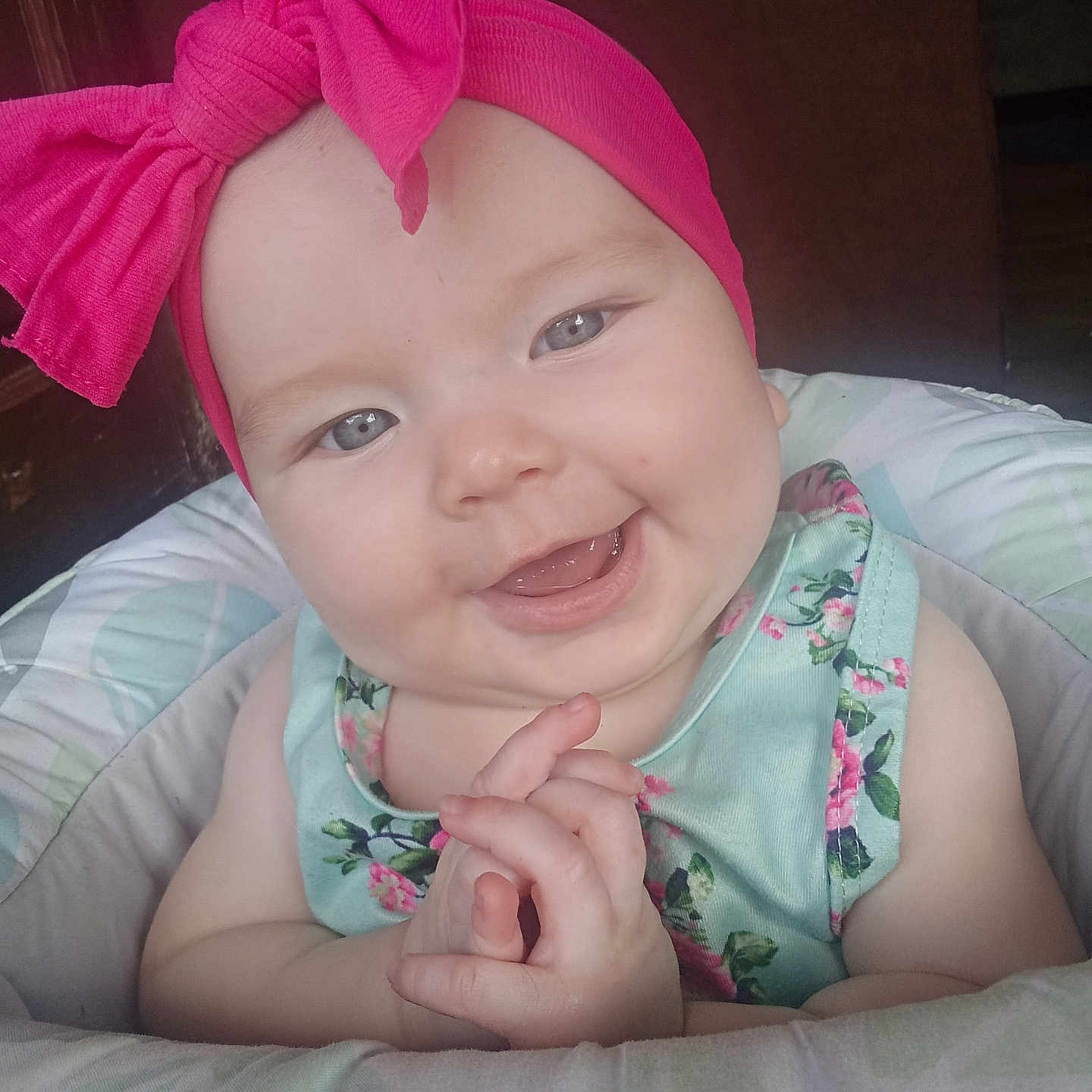 Eliana is registered to the contest to win money with this photo: baby, bow, child, clothing, cushion, cute, expression, eyes, face, floral, hands, happy, headband, indoor, infant, pink, portrait, seat, skin, smile