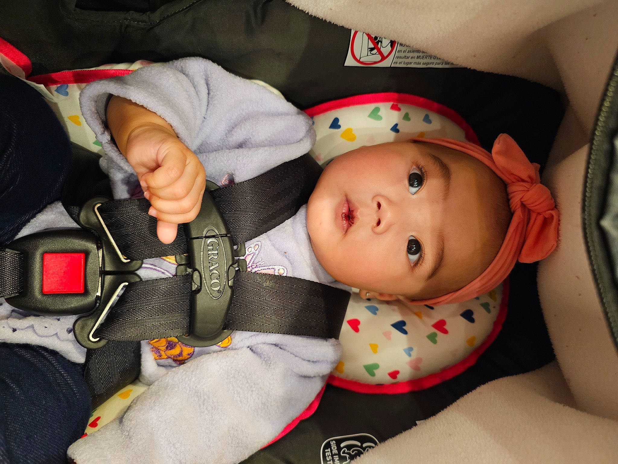 Rosie joined the competition — help win amazing prizes! auto_part, baby, baby_carriage, baby_in_car_seat, baby_products, baby_safety, baby_sleeping, baby_toddler_clothing, car_seat, carmine, cheek, child, comfort, finger, headwear, linens, person, seat_belt, sitting, textile