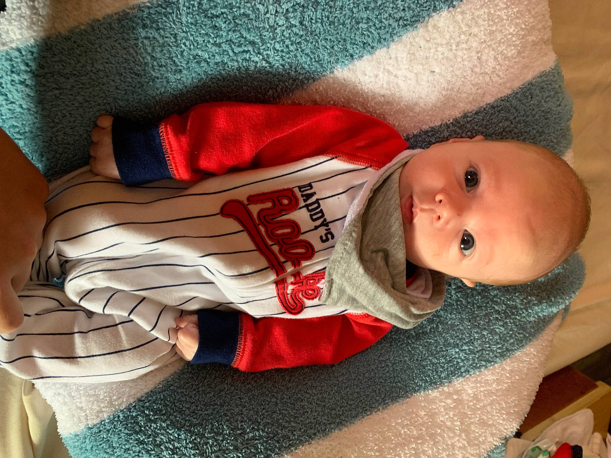 Kannon is registered to the contest to win money with this photo: baby, baby_toddler_clothing, cheek, child, chin, comfort, elbow, finger, head, human_body, lap, leg, mouth, nose, person, product, skin, sleeve, smile, textile