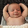 baby, sleeping, smile, arms_up, blanket, soft_texture, peaceful, infant, closeup, skin, relaxed, comfort, resting, cute, portrait, child, indoors, young, face, happy