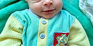 Barrett joined the competition — help win amazing prizes! baby, infant, smiling, face, eyes, hand, clothing, button, patch, moose, blanket, soft_texture, pastel_colors, cute, lying_down, portrait, child, newborn, cozy, happy
