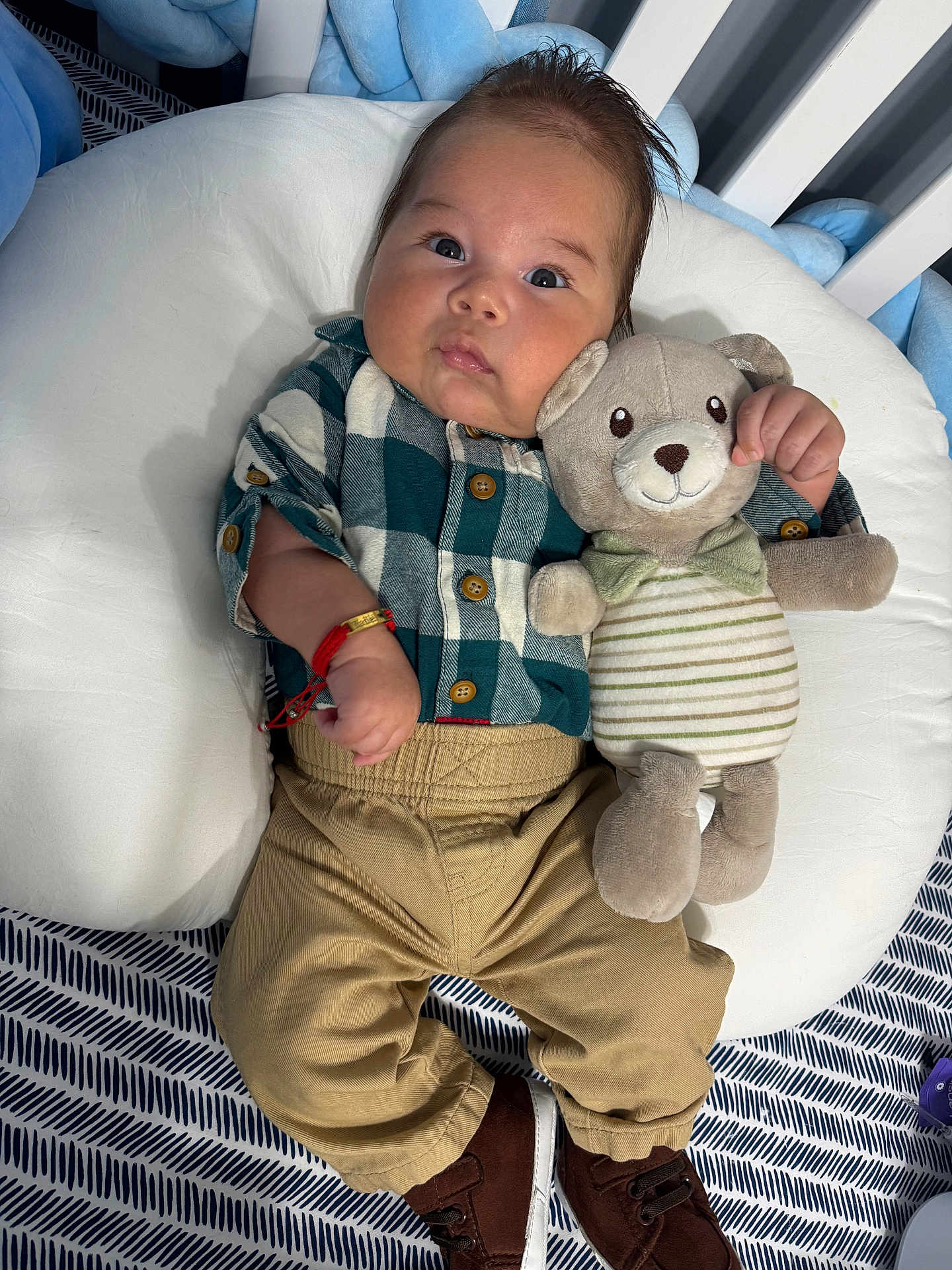 Yadiel joined the competition — help win amazing prizes! baby, plush_toy, teddy_bear, cushion, plaid_shirt, khaki_pants, brown_shoes, infant, cute, child, toy, bed, striped, bow_tie, bracelet, indoor, person, face, clothing, lying_down