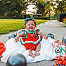 Soreiah joined the competition — help win amazing prizes! baby, child, birthday, cake, balloons, outdoor, grass, sidewalk, smile, celebration, dress, headband, blanket, red, green, black, fruit_theme, happy, one_year, festive