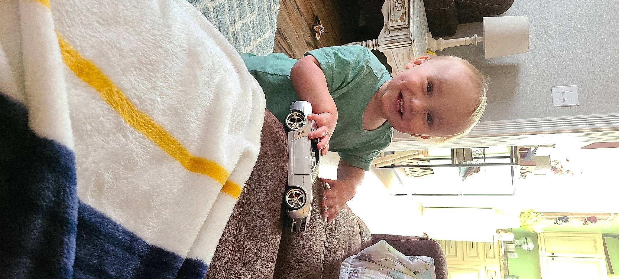 Ridge is registered to the contest to win money with this photo: baby, baby_products, baby_safety, baby_toddler_clothing, cheek, child, comfort, fun, happy, joy, pattern, person, plant, room, sitting, sleeve, smile, toddler, vacation, wood