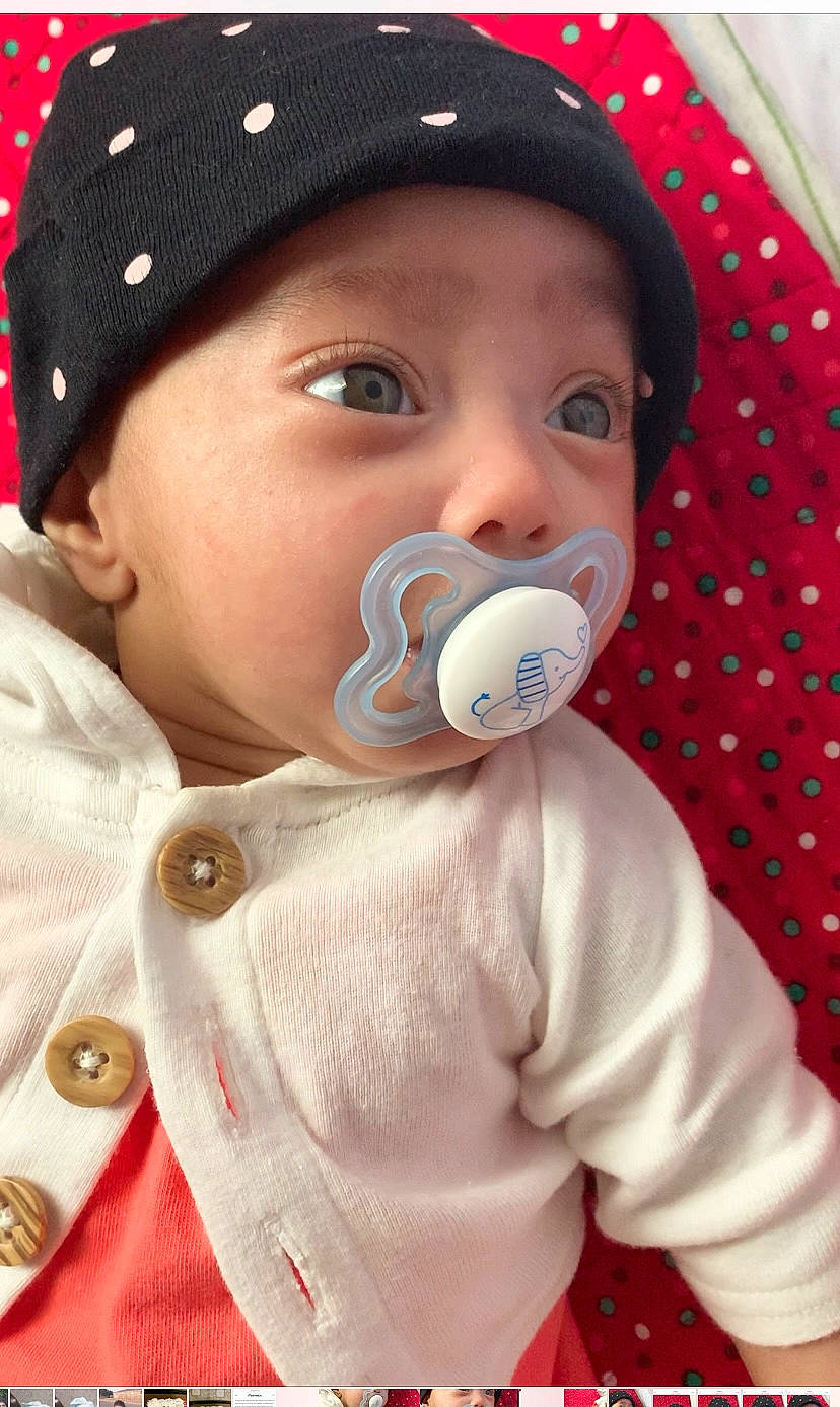 Irha is registered to the contest to win money with this photo: audio_equipment, baby, baby_products, baby_toddler_clothing, cap, cheek, child, face, happy, headwear, jacket, lip, nose, organ, outerwear, pattern, people, person, skin, sleeve