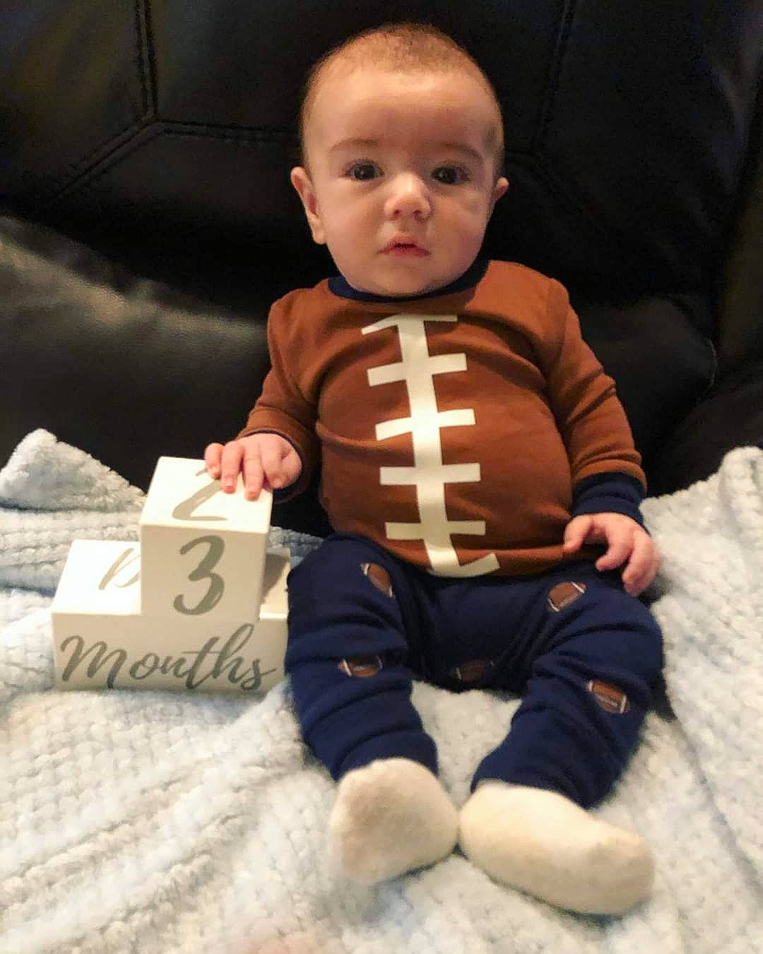 Bodhi is registered to the contest to win money with this photo: arm, baby, cheek, child, face, head, leg, person, sitting, skin, toddler