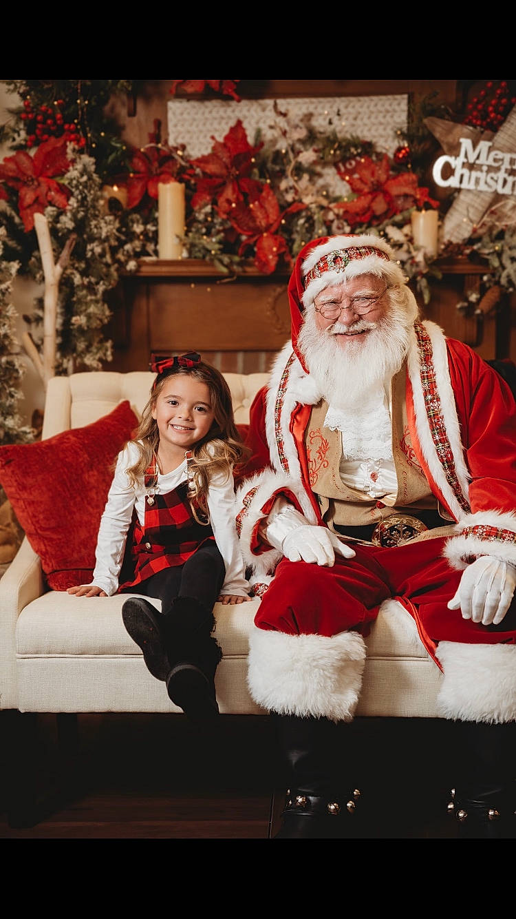 Mylah is registered to the contest to win money with this photo: beard, boot, christmas, christmas_decoration, christmas_eve, event, fictional_character, fun, fur, happy, holiday, joy, lap, person, plant, red, santa_claus, sitting, smile, tradition