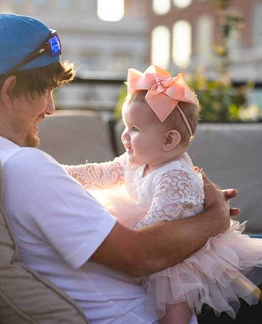 Evelyn joined the competition — help win amazing prizes! baby, baby_toddler_clothing, baseball_cap, bridal_accessory, bridal_clothing, cap, child, dress, embellishment, event, eyewear, fashion_accessory, fun, gesture, hand, happy, headpiece, peach, person, pink