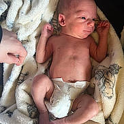 Rowan is registered to the contest to win money with this photo: newborn, baby, infant, diaper, blanket, hand, skin, foot, toe, arm, leg, face, expression, resting, soft, pattern, indoor, person, cute, sleepy