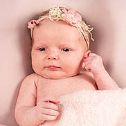 Olivia is registered to the contest to win money with this photo: baby, blanket, child, closeup, cute, face, flower, hand, headband, indoors, infant, lying_down, newborn, peaceful, pink, portrait, resting, skin, soft_texture, young
