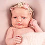 baby, blanket, child, closeup, cute, face, flower, hand, headband, indoors, infant, lying_down, newborn, peaceful, pink, portrait, resting, skin, soft_texture, young