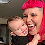 Ekhi participe au concours pour gagner de l'argent avec cette photo : baby, child, woman, person, smiling, happy, laughing, indoor, face, hair, pink_hair, holding, embrace, tongue, piercing, black_clothing, lamp, home, furniture, door