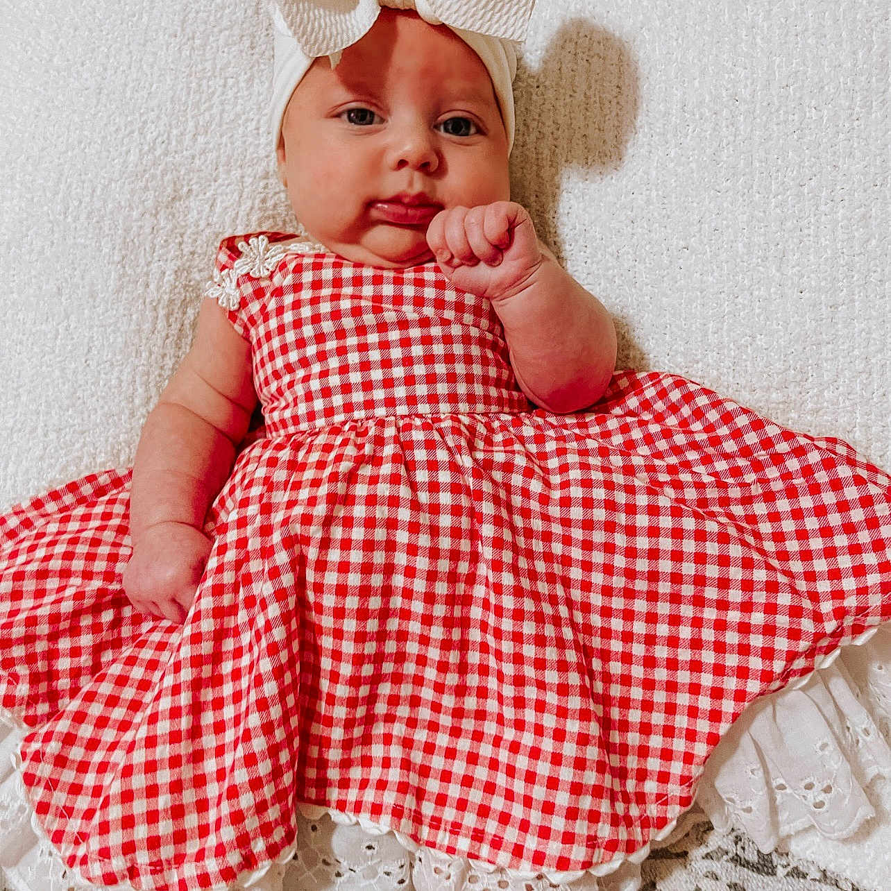 Oakley joined the competition — help win amazing prizes! baby, blanket, bodypart, bonnet, cap, clothing, dress, face, finger, hand, happy, hat, head, newborn, person, photography, portrait, sitting, sleeve, smile