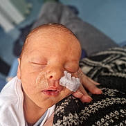 Vinnie joined the competition — help win amazing prizes! newborn, baby, sleeping, face, medical_tape, hand, blanket, knitted, closeup, infant, resting, soft, skin, person, peaceful, indoors, portrait, cute, young, care