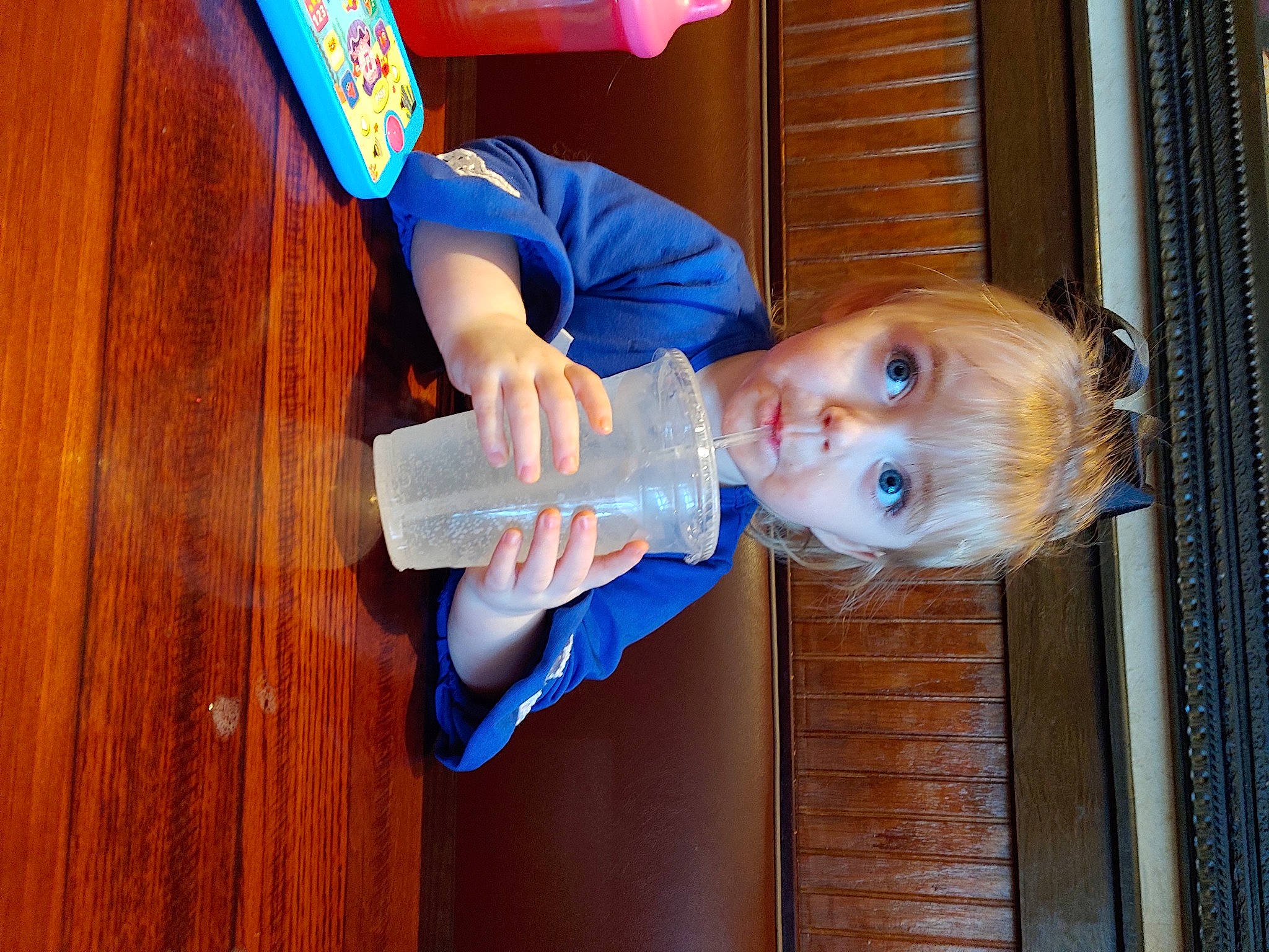 Breleigh is registered to the contest to win money with this photo: baby_toddler_clothing, blue, child, electric_blue, fun, hardwood, person, room, sleeve, smile, thumb, toddler, varnish, wood, wood_stain, wrist