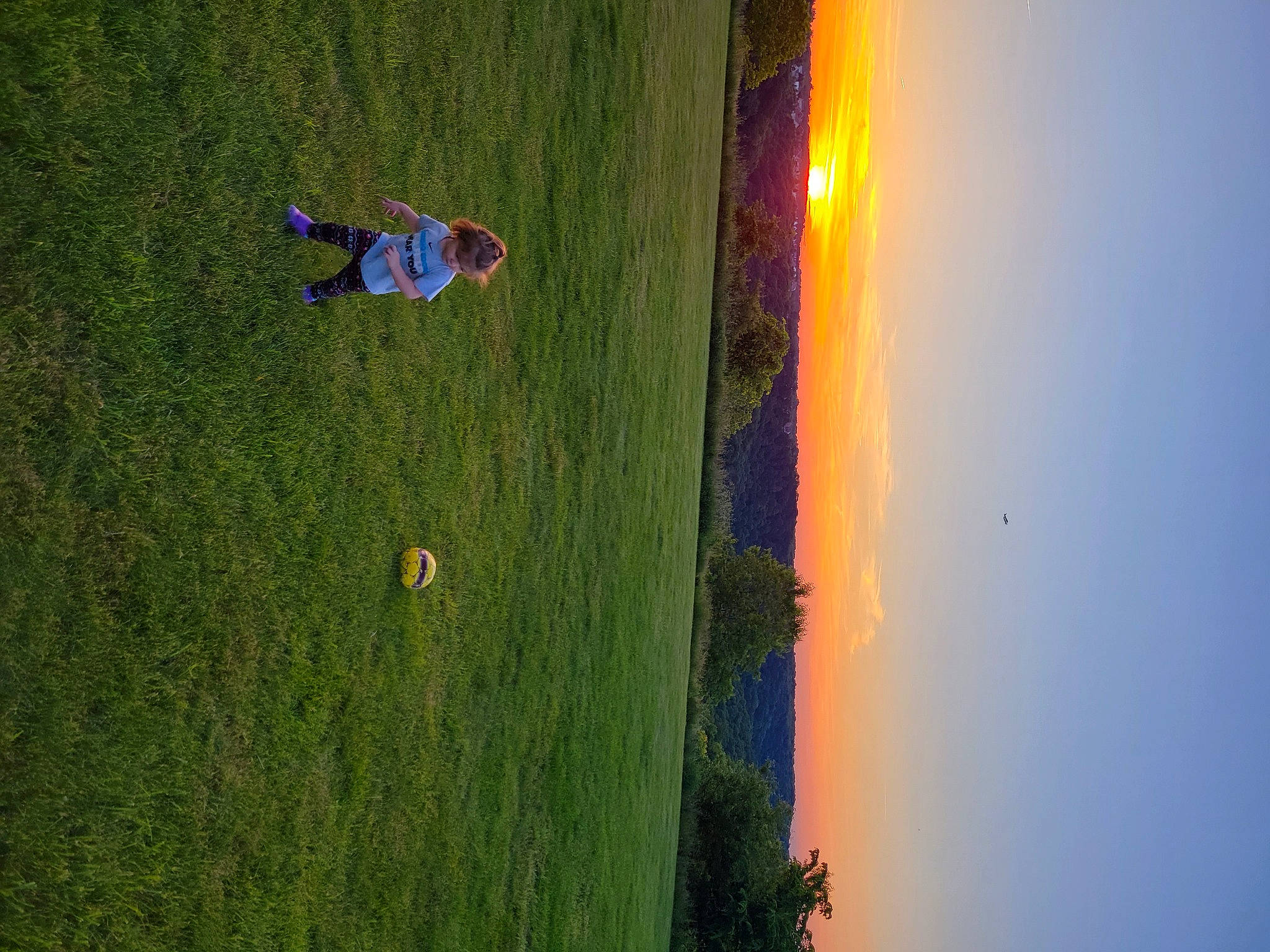 Charlee is registered to the contest to win money with this photo: aerial_photography, air_sports, evening, extreme_sport, field, grass, grassland, heat, horizon, landscape, leisure, people_in_nature, person, plant, recreation, shadow, sky, slope, tree, water