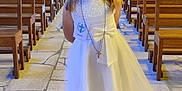 Elyna participe au concours pour gagner de l'argent avec cette photo : ceremony, child, church, cross_necklace, cute, event, floor_tiles, flower_crown, girl, indoor, lighting, people_in_background, pews, portrait, religious, smile, stone_wall, white_dress, wooden_benches, young