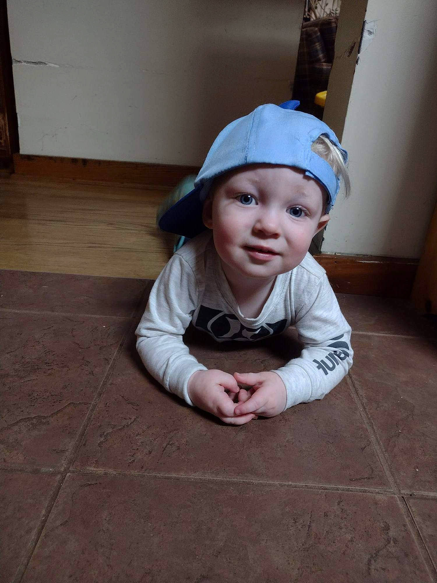 Isaiah joined the competition — help win amazing prizes! baby, baby_toddler_clothing, cap, child, clothing, costume_hat, fashion_accessory, flash_photography, floor, flooring, fun, grass, hardwood, hat, headwear, human_body, person, road_surface, sitting, sleeve
