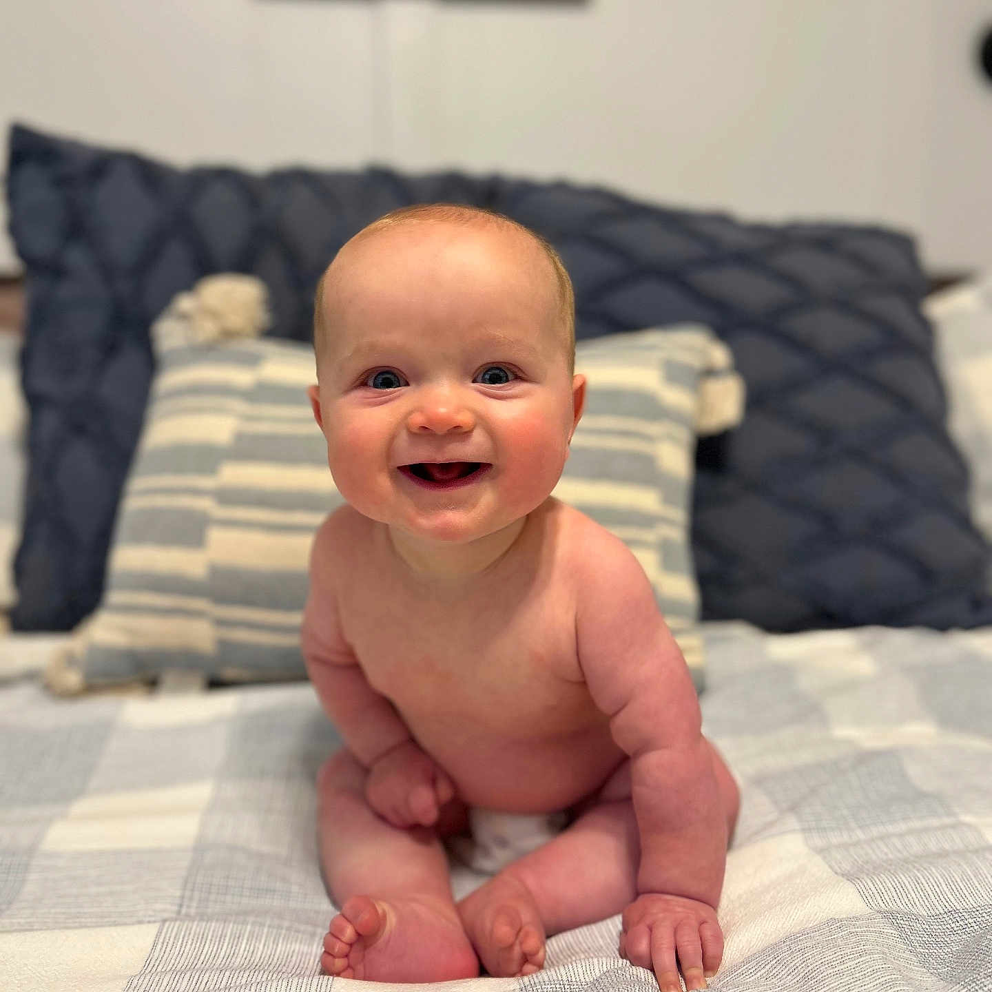 Ty is registered to the contest to win money with this photo: baby, bed, blanket, cheerful, child, comfort, cute, expression, happy, human, indoors, infant, person, pillow, plush, sitting, skin, smiling, soft, young