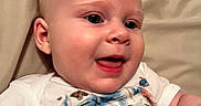Hazel joined the competition — help win amazing prizes! baby, child, smiling, closeup, face, person, infant, cute, happy, skin, eyeball, mouth, clothing, short_sleeve_shirt, hand, background, lying_down, indoor, young, human