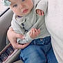 Adeline is registered to the contest to win money with this photo: baby, infant, child, headband, bow, blue_eyes, sweater, jeans, hand, sitting, car_interior, car_seat, adult_hand, portrait, cute, rosy_cheeks, soft_lighting, clothing, lap, cozy