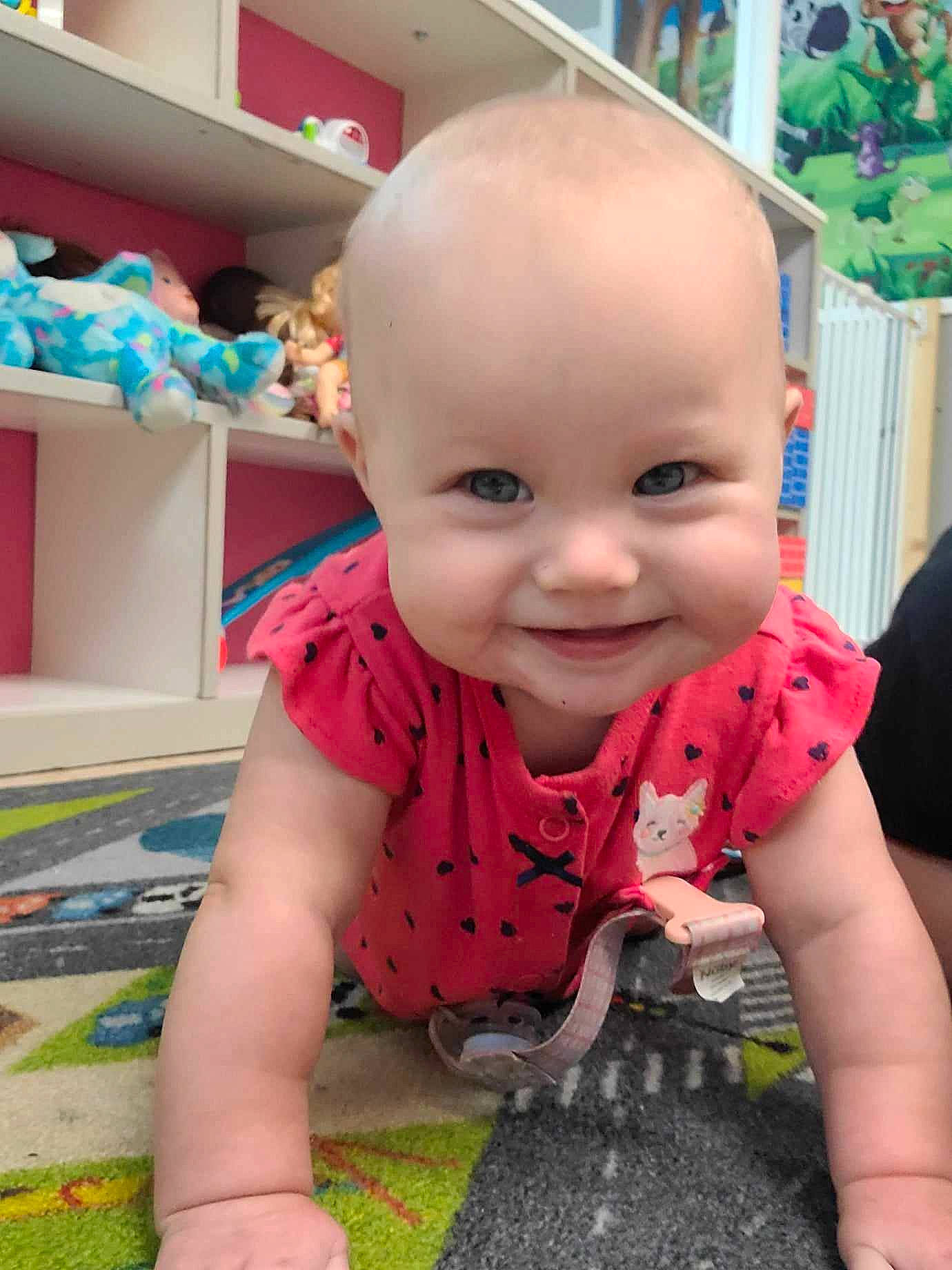 Emery joined the competition — help win amazing prizes! baby, baby_toddler_clothing, cheek, child, crawling, eye, flooring, fun, grass, happy, joy, leisure, pattern, person, pink, play, shelf, sitting, skin, smile