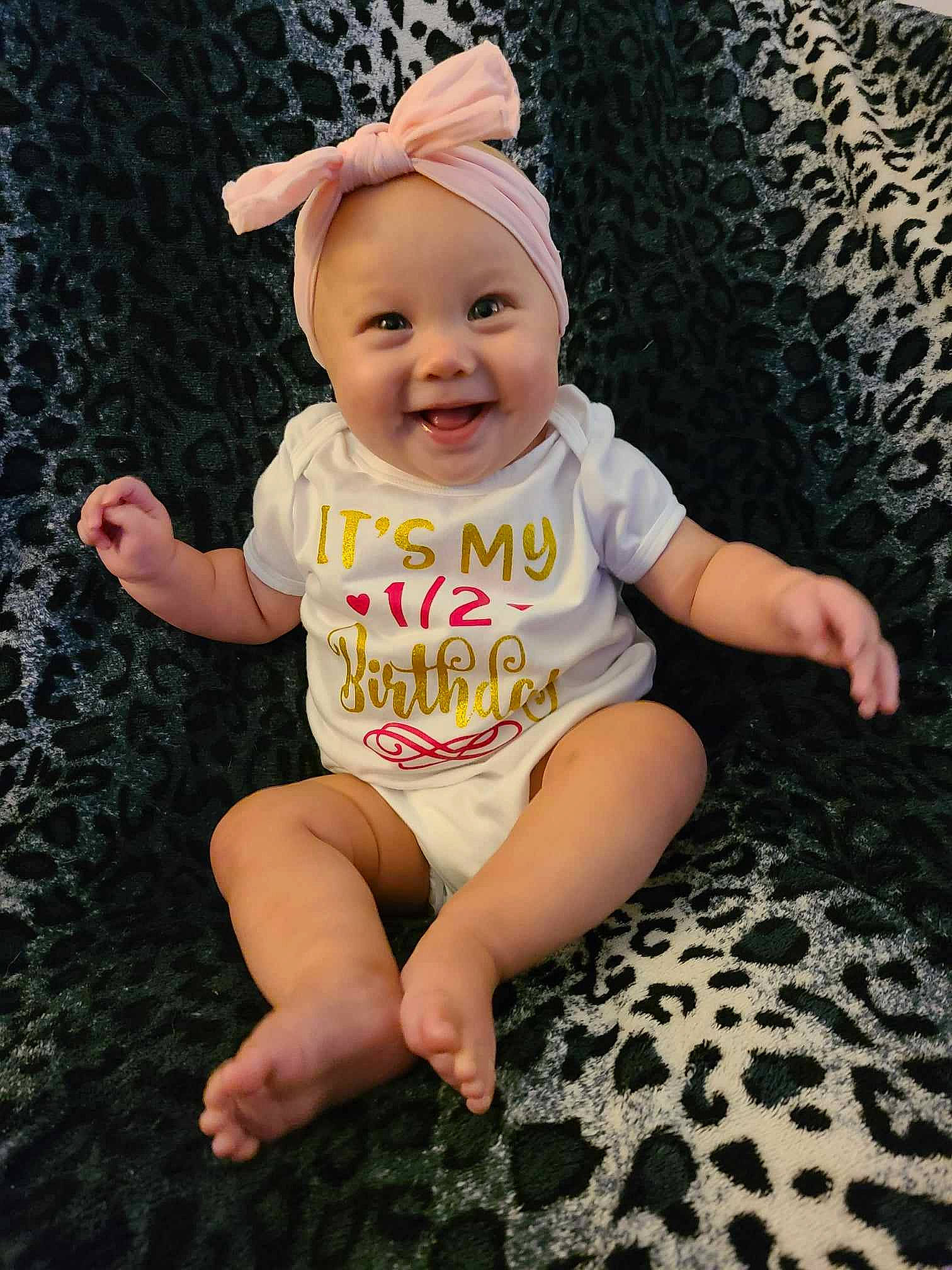 Emery joined the competition — help win amazing prizes! baby, baby_toddler_clothing, barefoot, cap, child, cool, facial_expression, foot, fun, grass, happy, headwear, human_leg, joy, pattern, person, pink, sitting, skin, sleeve