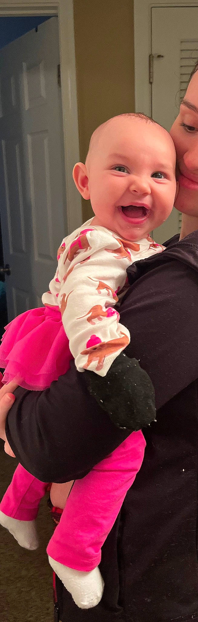 Giana is registered to the contest to win money with this photo: abdomen, baby, baby_laughing, baby_toddler_clothing, event, formal_wear, fur, gesture, happy, hat, human_body, lip, magenta, neck, person, pink, sitting, sleeve, smile, thumb