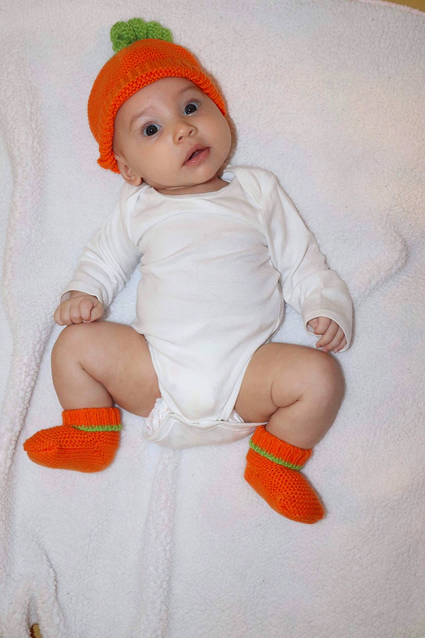 Giana is registered to the contest to win money with this photo: arm, art, baby, baby_products, baby_toddler_clothing, cap, carmine, child, costume_hat, face, facial_expression, fashion_accessory, gesture, happy, hat, headwear, orange, person, sleeve, smile