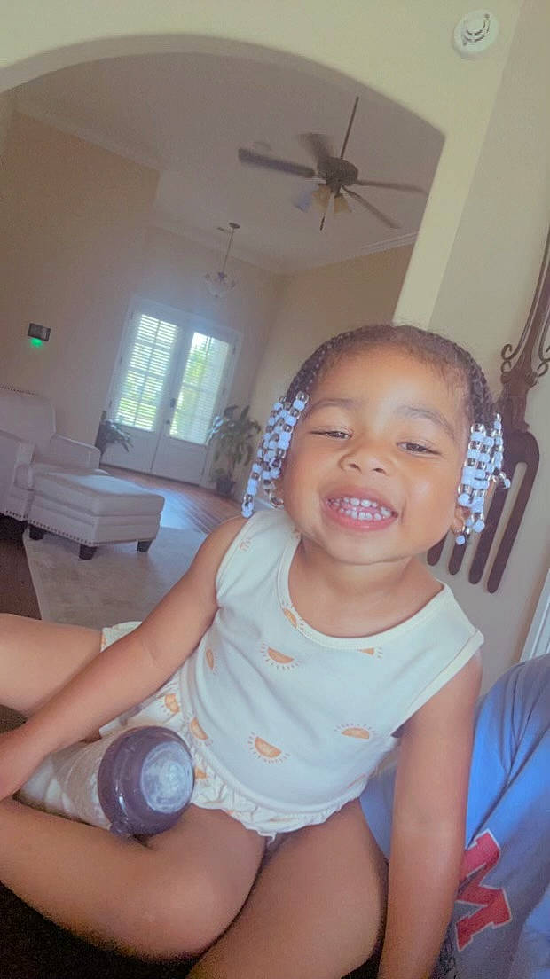 Miah is registered to the contest to win money with this photo: baby, baby_toddler_clothing, ceiling_fan, chair, finger, gesture, hand, happy, human_leg, joint, joy, knee, leg, mouth, person, skin, smile, thigh, thumb, toddler