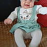 baby, child, headband, smile, clothing, tights, sitting, blanket, cushion, happy, face, indoor, person, cute, infant, apparel, pattern, fabric, playful, motion