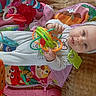 baby, child, toy, play_mat, colorful, infant, headband, indoor, cute, smiling, hands, face, person, happy, soft, fabric, play, young, bright, comfort