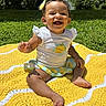 baby, child, smiling, happy, outdoor, portrait, sitting, blanket, yellow_blanket, grass, garden, backyard, trees, sunlight, bow, headband, infant, clothing, barefoot, nature