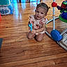 Aria joined the competition — help win amazing prizes! toddler, child, baby, portrait, smiling, kneeling, indoor, wooden_floor, playroom, toy, ride_on_toy, colorful, floral_clothing, dress, short_hair, face, person, furniture, water_bottles, home